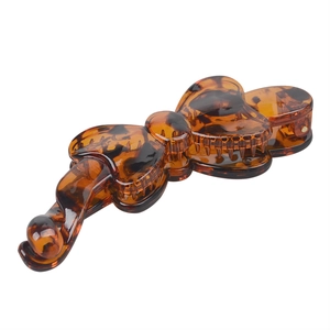 Close-up of tortoise shell resin banana clip with bow design and inner grip teeth