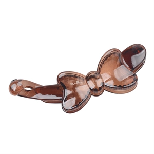 Detailed view of the brown translucent resin bow banana clip with polished finish