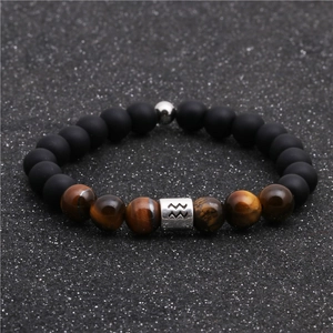 Macro shot of tiger eye beads and matte black stone on an Aquarius zodiac bracelet