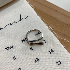 Detailed view of 925 sterling silver minimalist geometric ring on linen background