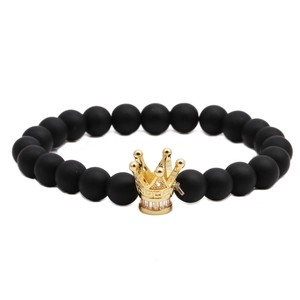 Men's matte black beaded bracelet with a gold crown charm and crystal inlays