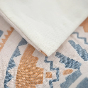 Gauze cotton pillowcase pair with blue and orange geometric tribal pattern and cream back