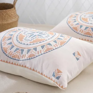 Pair of Bohemian cotton gauze pillowcases with geometric patterns in a cozy home setting