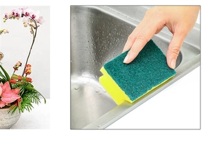 Close-up of dual-sided yellow and green cleaning sponge used on a stainless steel sink