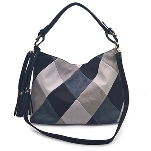 Fashionable diamond patchwork PU leather shoulder bag with decorative tassel on white background