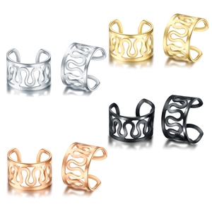 Macro detail of wave patterned ear cuffs in silver gold black and rose gold steel