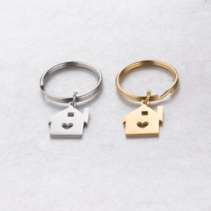 Set of polished stainless steel house-shaped keychains with heart cut-outs in gold and silver
