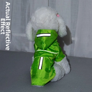 Detail view of reflective dog raincoat with neon green honeycomb texture and safety stripes