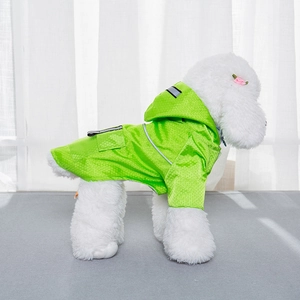 Detail of bright green waterproof dog raincoat with reflective safety stripes and hood