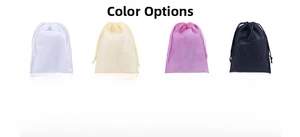 Detail of four multi-colored non-woven drawstring storage bags in white, beige, pink and black