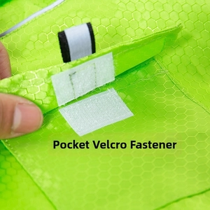 Detail view of the fluorescent green pet raincoat with functional pocket hook and loop fastener