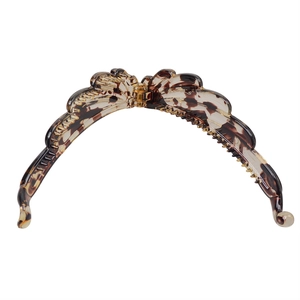 Close-up of tortoise shell pattern resin banana clip with durable spring mechanism