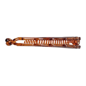 Close-up of a translucent brown resin banana hair clip with a stylish twisted design