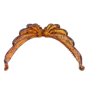 Close-up of tortoise shell pattern banana hair clip in amber resin with inner comb teeth
