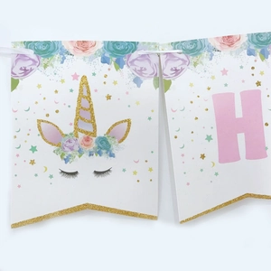 Detail of glitter gold unicorn horn and flower design on white happy birthday banner