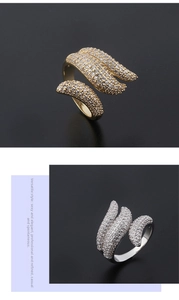 Detail of gold and silver open rings with pavé cubic zirconia in a wing design