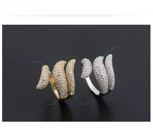 Detailed view of wrap rings with gold and silver finishes and micro-paved zircons