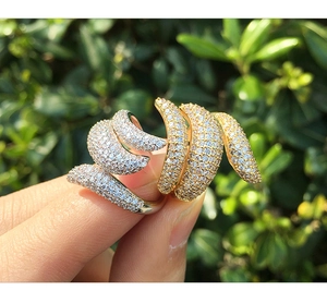 Detailed close-up of a two-tone snake-style ring with shimmering pavé cubic zirconia