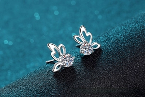 Vue macro de boucles d'oreilles en argent avec moissanite ronde étincelante et design papillon