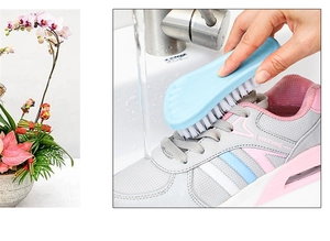 Action shot of blue stiff bristle brush cleaning a pink and grey sneaker under running water
