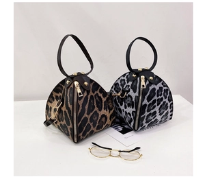 Detail of leopard print triangle bags with metal ring handles and detachable straps