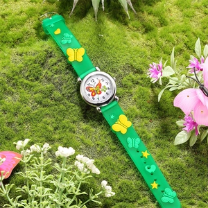 Children's green butterfly quartz watch with translucent silicone strap on moss background
