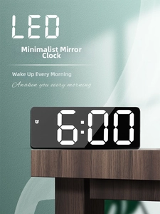 Macro shot of minimalist LED mirror alarm clock with white digital display on wood table