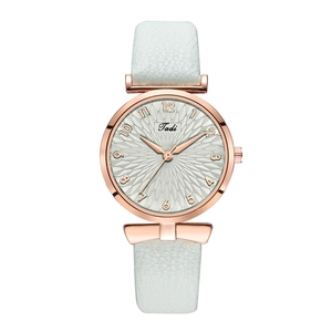 Detail of elegant rose gold bezel and white leather strap on a stylish quartz watch