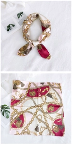 Detail of red and beige silk scarf with baroque gold chain and vintage key patterns