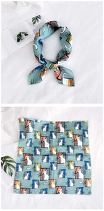 Detail of teal square scarf with cartoon cat print showing tied and flat styles