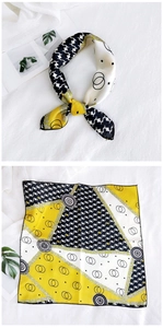 Detail view of yellow silk scarf with houndstooth pattern and geometric ring prints