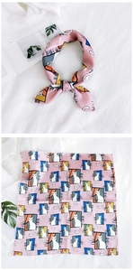 Close-up of pink silk scarf with cute cat and window print, styled as a necktie