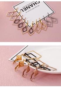Close-up of geometric double-layered rhombus drop earrings in four metallic finishes
