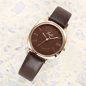 Macro detail of Tadi women's minimalist quartz watch with brown leather strap and rose gold case