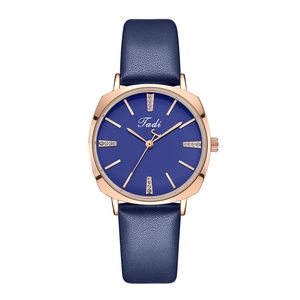 Detail of rose gold case with navy blue leather strap and crystal indices on Tadi watch