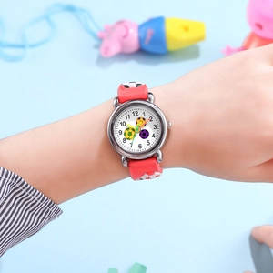 Close-up of children's soccer watch with 3D embossed red silicone strap and quartz dial
