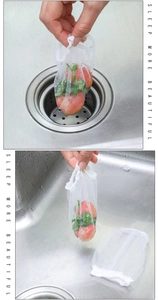 Mesh sink strainer bag capturing food waste from a stainless steel kitchen drain