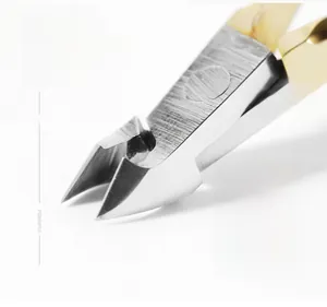 Macro shot of D-501 stainless steel cuticle nipper with sharp blades and gold handles