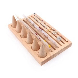 Beech wood jewelry display stand with conical ring holders and earring slots
