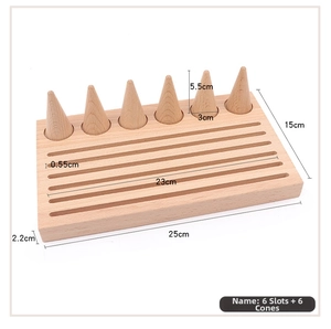 Wooden jewelry display stand with six conical ring holders and tiered slots on a wood base