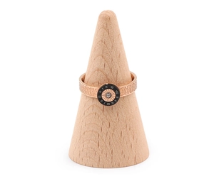 Detailed view of rose gold ring with Roman numerals on a wooden cone display stand