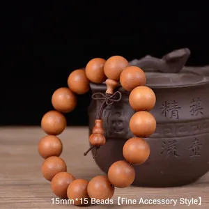 Detail of 15mm sandalwood prayer beads showing natural wood grain and gourd pendant