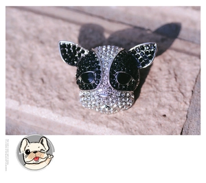 Macro shot of French Bulldog brooch featuring black and white crystals on silver base