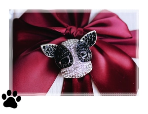 Detailed view of French Bulldog brooch with black and white rhinestones on red silk