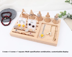 Detailed view of wooden jewelry display stand with ring cones and multiple storage slots