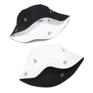 Detail of reversible cotton bucket hat with colorful embroidered pineapple patterns