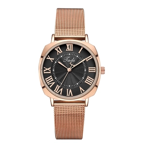Detail of rose gold mesh watch with square case and black Roman numeral dial