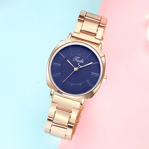 Minimalist women's quartz watch with rose gold metal band and navy blue matte dial face