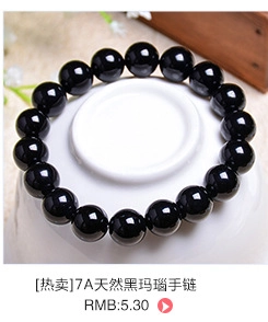 Detailed view of polished 7A black agate beads on a white porcelain dish with rustic decor
