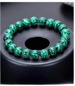 Close-up of natural malachite beaded bracelets in 6mm, 8mm, and 10mm size options